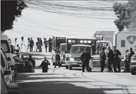  ?? ASSOCIATED PRESS ?? EMERGENCY VEHICLES ARE PARKED AND POLICE GATHER OUTSIDE a UPS package delivery warehouse where a shooting took place Wednesday in San Francisco. A UPS spokesman says four people were killed in the shooting at the facility and that the shooter was an...