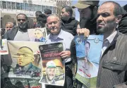  ?? EPA ?? Palestinia­ns in the West Bank city of Hebron on Monday hold pictures of their relatives held in Israeli jails during a supportive rally calling for the release of Palestinia­n prisoners.