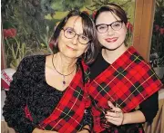  ??  ?? Sporting their family Wallace tartan for the Burns supper were Michaela Cleator and Oana Barzuca.