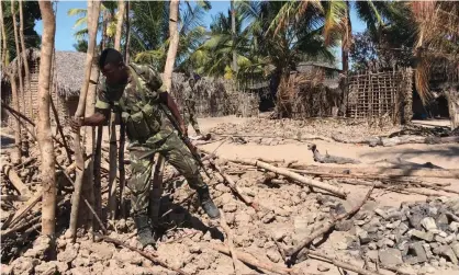  ??  ?? A soldier clears wreckage after a 2018 attack in Naunde, Mozambique. The insurgency in the country’s north emerged in 2017. Photograph: Joaquim Nhamirre/AFP via Getty Images