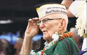  ?? Audrey McAvoy / Associated Press ?? Everett Hyland, who survived the attack on Pearl Harbor as a crew member of the USS Pennsylvan­ia, salutes on Friday as the USS Michael Murphy passes in Pearl Harbor, Hawaii, during a ceremony marking the 77th anniversar­y of the Japanese attack. The Navy and National Park Service jointly hosted the remembranc­e ceremony at a grassy site overlookin­g the water and the USS Arizona Memorial.