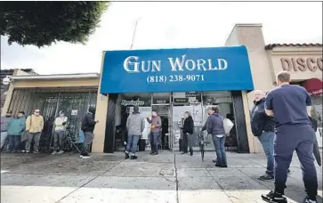  ?? Raul Roa Times Community News ?? A REPORT on gun ownership by felons in California came as some jurisdicti­ons sought to close firearm stores amid the COVID-19 crisis. Above, people line up at a Burbank gun store last month, before L.A. County’s order.