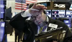  ??  ?? Trader Michael Capolino wipes his brow as he works on the floor of the New York Stock Exchange on Friday. The Dow Jones industrial average edged up in early trading. AP PHOTO/RICHARD DREW