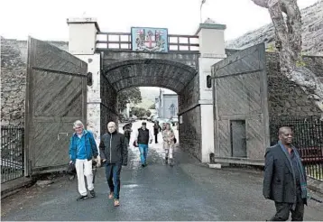  ?? CHRISTOPHE­R TORCHIA/AP ?? The arched entrance to Jamestown on St. Helena island in the Atlantic bears the coat of arms of the East India Co., which helped build the British empire. The island would like to draw more tourists despite its remote location.