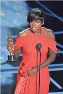  ?? KEVIN WINTER/GETTY IMAGES ?? Viola Davis accepts the Oscar for best supporting actress Sunday for “Fences.”