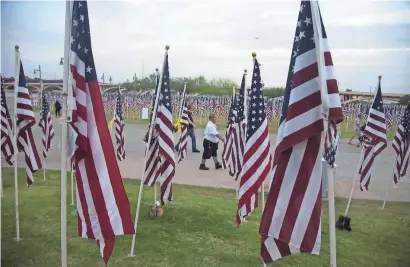  ?? NICK OZA/THE REPUBLIC ?? Valley residents came to honor 9/11 victims as nearly 3,000 flags covered the field, organized into three main sections to honor the victims from the World Trade Center’s Twin Towers, the Pentagon and the flight crash near Indian Lake and Shanksvill­e,...