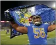  ?? MARCIO JOSE SANCHEZ — THE ASSOCIATED PRESS ?? UCLA offensive lineman Atonio Mafi (56) celebrates the team’s win over LSU in an NCAA college football game Saturday, Sept. 4, 2021, in Pasadena, Calif.