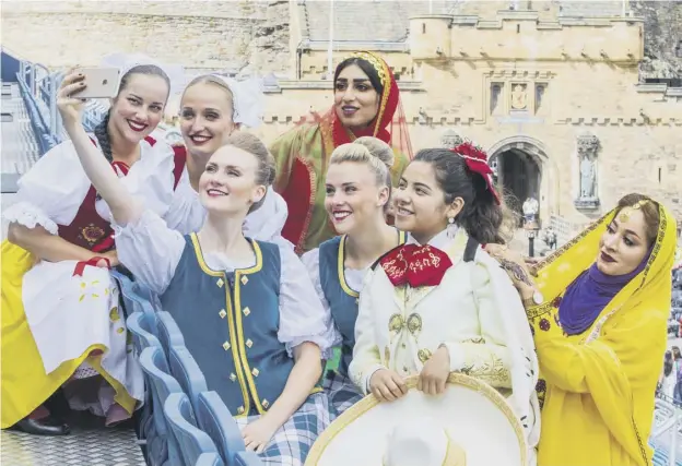  ??  ?? 0 Czech dancers, Oman marching band members, Mexican dancers and Highland Dancers at the launch of the 2018 Royal Edinburgh Military Tattoo yesterday