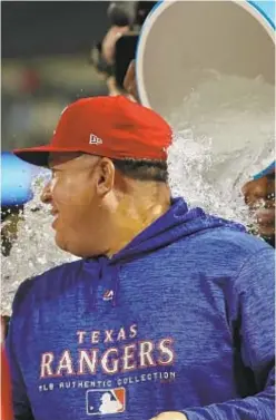  ?? GETTY ?? Rangers’ Bartolo Colon celebrates after becoming winningest Latin American-born pitcher. Now he has another goal.