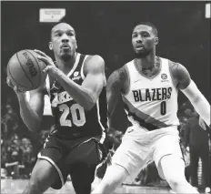  ?? STEVE DYKES/AP ?? LOS ANGELES LAKERS GUARD AVERY BRADLEY (left) drives to the basket on Portland Trail Blazers guard Damian Lillard during the first half of a game in Portland, Ore. on Saturday.