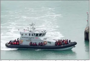  ?? (AP/PA/Gareth Fuller) ?? A group of people thought to be migrants are brought in to Dover, Kent, onboard a Border Force vessel, following a small boat incident Monday in the English Channel.