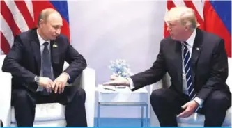  ??  ?? HAMBURG: This file photo taken on July 7, 2017 shows US President Donald Trump and Russia’s President Vladimir Putin shaking hands during a meeting on the sidelines of the G20 Summit. —AFP