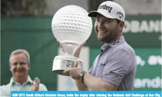  ??  ?? SUN CITY: South Africa’s Brandon Grace, holds the trophy after winning the Nedbank Golf Challenge at Sun City, South Africa, yesterday. — AP