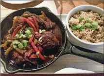  ?? CONTRIBUTE­D BY WENDELL BROCK ?? The brown-stew chicken with rice and peas is a standout at Ms. Icey’s Kitchen &amp; Bar in Decatur.