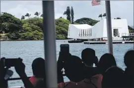  ?? Kent Nishimura Los Angeles Times ?? VISITORS can take in the USS Arizona Memorial from afar as it awaits repairs. The rest of the World War II Valor in the Pacific National Monument is open.