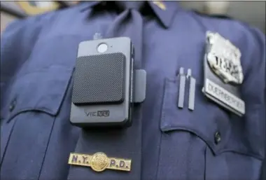  ?? MARY ALTAFFER — THE ASSOCIATED PRESS FILE ?? A police officer wears a newly issued body camera at the 34th precinct in New York. A union representi­ng New York City police officers sued the department Tuesday saying its release of body camera footage without a court order violates a state law that...