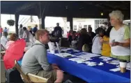  ?? JORDANA JOY — THE MORNING JOURNAL ?? United Healthcare in Amherst sales agent Robert Litz, left, speaks with senior citizens and veterans during the Lorain County Fair, 23000 Fairground­s Road in Wellington, on Aug. 22. Vendors were set up at Pavilion 1.