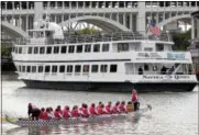  ?? AMY SANCETTA — THE ASSOCIATED PRESS FILE ?? A dragon boat waits for the tour boat the Nautica Queen to pass.