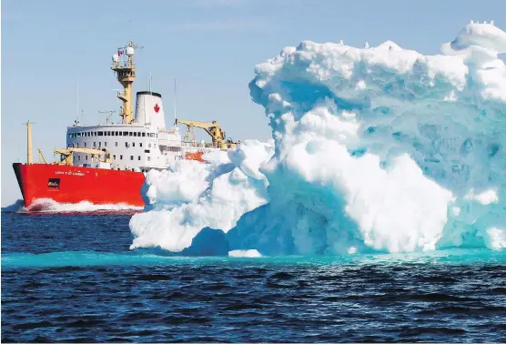  ?? JONATHAN HAYWARD/THE CANADIAN PRESS ?? The Canadian Coast Guard icebreaker Louis S. St-Laurent sails past an iceberg in Lancaster Sound, Nunavut. Canada is seeking to replace its aging fleet with interim icebreaker­s. However, they are seen as only partly addressing Canada’s lagging profile...