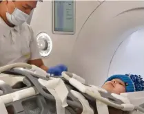  ??  ?? Brave: Amelia has a scan during her treatment