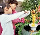  ??  ?? The Japanese custom of bathing a statue of the baby Prince Siddhatha