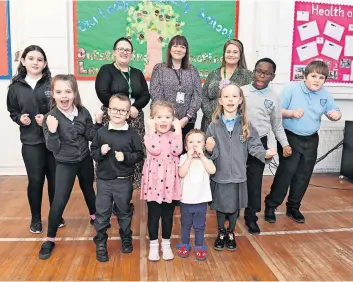  ?? ?? Class of their own Our Lady’s staff and pupils celebrate their excellent report from inspectors