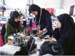  ??  ?? TEHRAN: Iranian students prepare their robots during the internatio­nal robotics competitio­n, RoboCup Iran Open 2016, in Tehran, Iran. Universiti­es in US say President Donald Trump’s revised travel ban would block hundreds of graduate students who play...