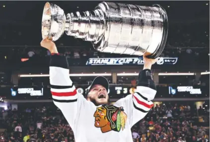  ?? Bruce Bennett, Getty Images North America ?? Jonathan Toews of the Chicago Blackhawks hoists the Stanley Cup after defeating the Boston Bruins 3-2 in Game 6 of the Finals onMonday night at TD Garden.