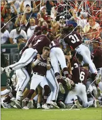  ?? JOHN PETERSON — THE ASSOCIATED PRESS ?? Mississipp­i State celebrates after winning the College World Series 9-0against Vanderbilt in the deciding Game 3on Wednesday in Omaha, Neb.