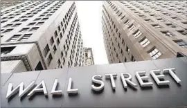  ?? MARK LENNIHAN Associated Press ?? A JULY survey showed that inf lation expectatio­ns have held steady or improved, along with general consumer sentiment. Above, buildings line Wall Street in 2020.