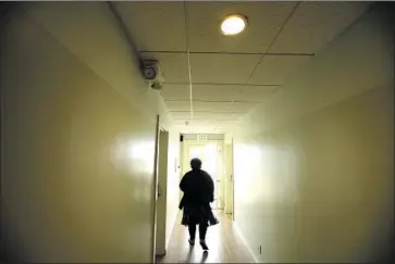  ?? Genaro Molina Los Angeles Times ?? WENDY BROWN walks through a hallway at the Cadillac Hotel in Venice. She is one of the eligible homeless people who got a room under Project Roomkey. Of the 15,000 people eligible, only a quarter are housed.