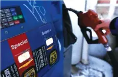  ?? AP PHOTO/CARLOS OSORIO ?? The price of regular gas at the pump in Chattanoog­a averages nearly 68 cents a gallon less than a year ago