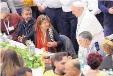  ?? ANDREW MEDICHINI/ASSOCIATED PRESS ?? Pope Francis greets people at a lunch at the Vatican on Sunday as he offered about 1,500 poor people, homeless, migrants, and unemployed a lunch to celebrate the World Day of the Poor.