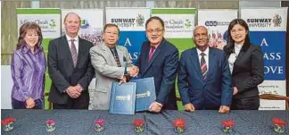  ??  ?? Lim Teck Ting (third from left) exchanging documents with Tan Sri Razman Hashim. With them are (from left) Sunway Education Group senior executive director Dr Elizabeth Lee, Sunway University vice-chancellor Professor Graeme Wilkinson, member of Jeffrey Cheah Foundation board of trustees and Sunway University pro-chancellor Tan Sri Ramon Navaratnam and SMM Education Group managing director Dr Goh Hui Chyn.