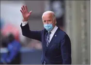  ?? ANGELA WEISS/AFP / TNS ?? President-elect Joe Biden waves as he leaves The Queen in Wilmington, Del., on Tuesday. President-elect Joe Biden said he had told several world leaders that “America is back” after his defeat of Donald Trump in the bitterly contested U.S. election.