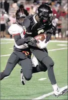  ??  ?? Rossview’s Tequan Evans, who scored the lone touchdown for the Hawks on offense, brings down Whitehaven receiver Braylen Rochell.