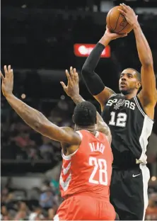  ?? Darren Abate / Associated Press ?? The Spurs’ LaMarcus Aldridge shoots over the Rockets’ Tarik Black during the second half of San Antonio’s win at home.
