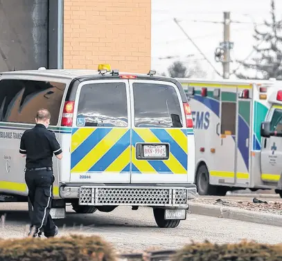  ?? POSTMEDIA NEWS ?? Alberta Health Services ambulances and paramedics were photograph­ed at the Peter Lougheed Centre in Calgary on Jan. 17.