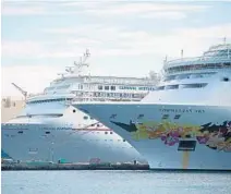  ?? ANDREW CABALLERO-REYNOLDS/GETTY ?? A Norwegian Cruise Line ship and a Carnival ship are docked at the port in Nassau, Bahamas, two weeks after Hurricane Dorian pounded the nation’s northern islands in late August.