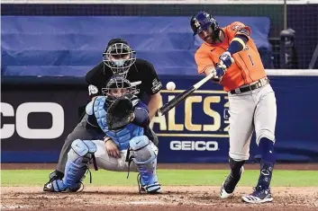  ?? JAE C. HONG/ASSOCIATED PRESS ?? Houston’s Carlos Correa hits a double during a two-run rally by the Astros in the seventh inning against Tampa Bay on Friday.