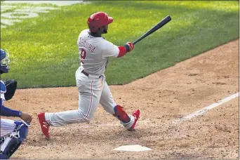  ?? ADAM HUNGER — THE ASSOCIATED PRESS ?? Phillies infielder Jean Segura hits a two-run home run during the 10th inning Monday as the Phillies attained a split in their series with the Mets at Citi Field in New York.