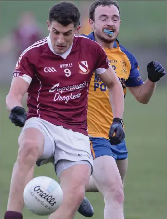  ??  ?? Rian Hand, Kilkerley keeps pace with Robert Brodigan, Oliver Plunkett’s. Picture: Ken Finegan