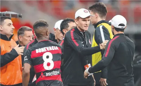  ??  ?? FIRM HAND: Wanderers coach Hayden Foxe celebrates winning the Round 1 A-League match against the Glory. Picture: CAMERON SPENCER